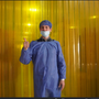 A man in a blue outfit at a cocoa factory