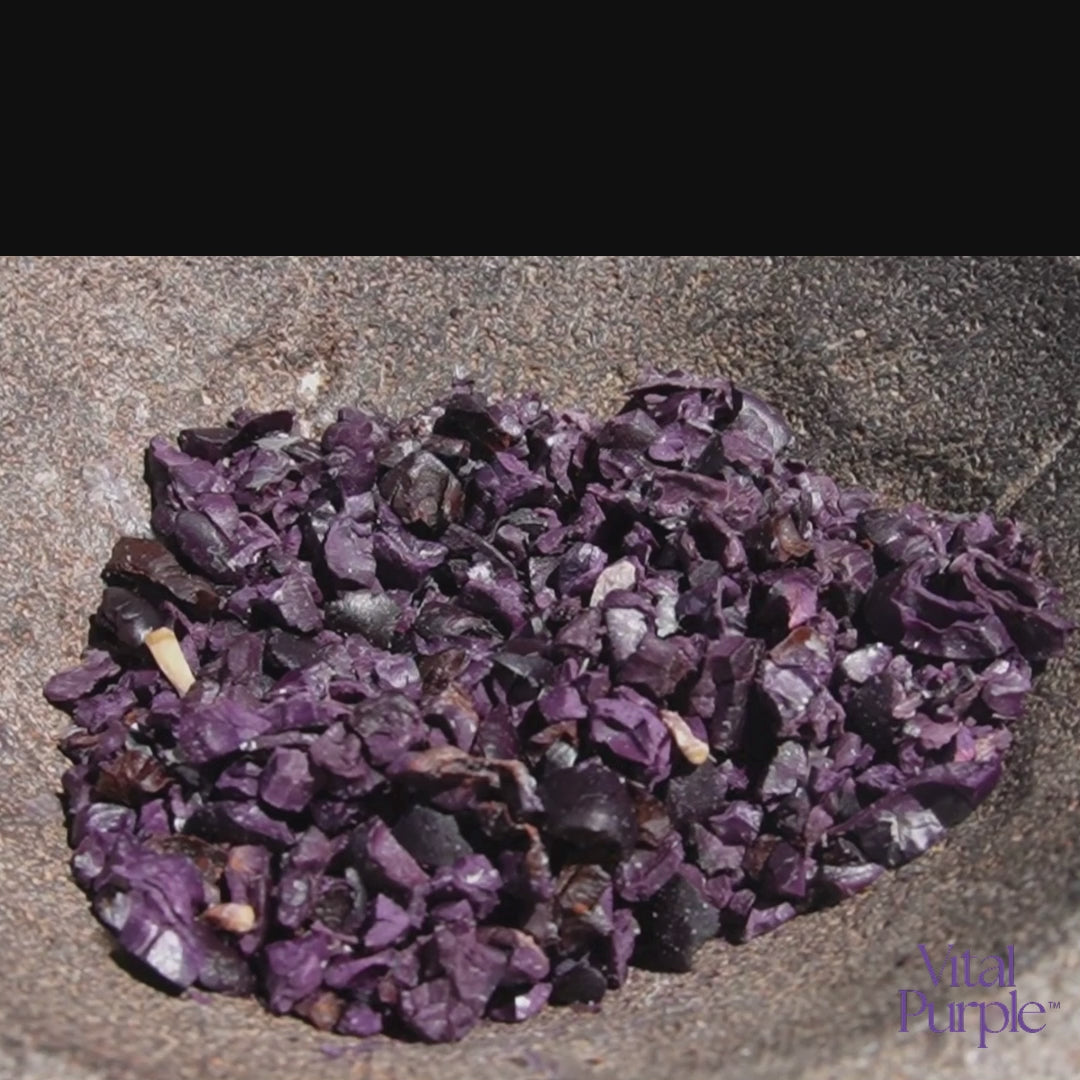 Organic Cocoa Nibs being ground up with a mortar and pastel. 